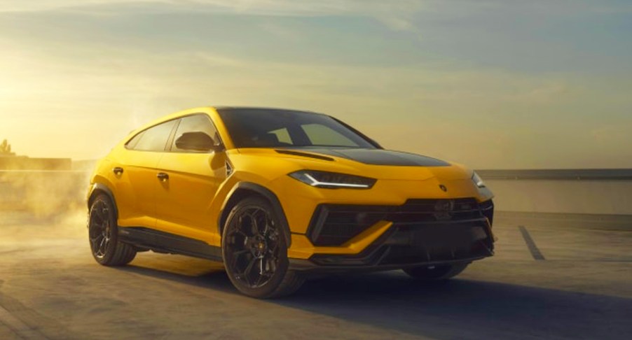 A yellow 2023 Lamborghini Urus Performante is driving on the road.