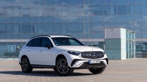 A white Mercedes-Benz GLC parked in front of a building.