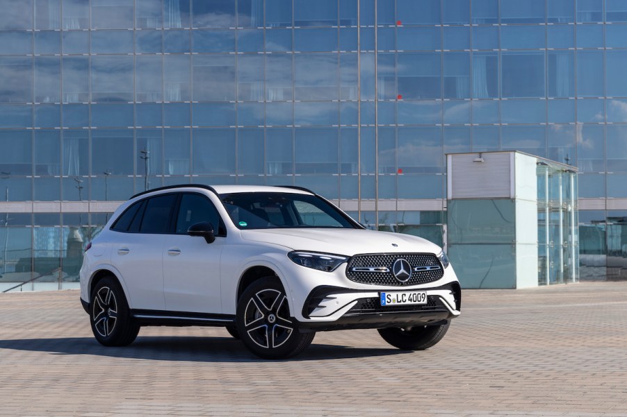 A white Mercedes-Benz GLC parked in front of a building.