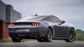 A gray 2024 Ford Mustang EcoBoost parks in a harbor.