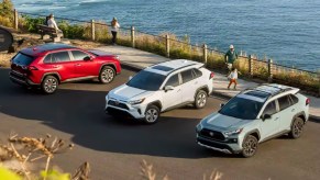 Three Toyota RAV4 small SUVs are parked.