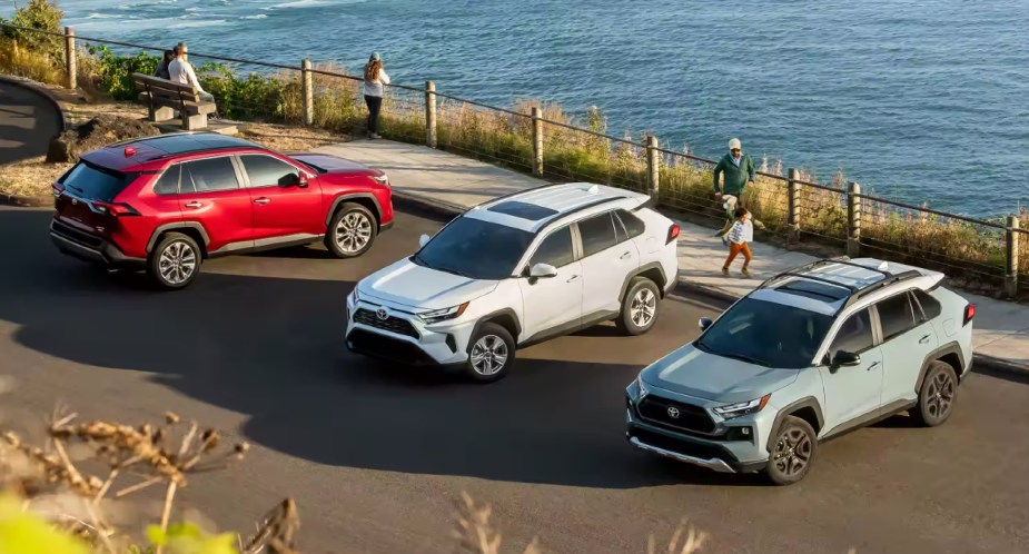 Three Toyota RAV4 small SUVs are parked. 