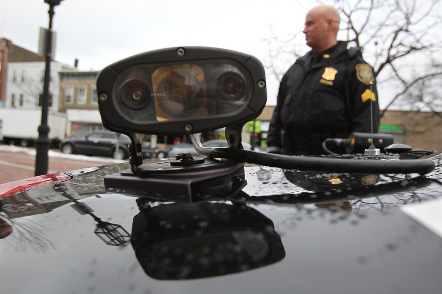 Closeup of an automatic license plate reader scanner camera on the roof of a police SUV.