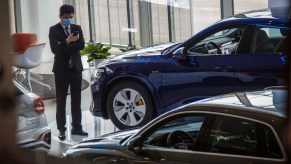 A person potentially preparing to buy an expensive luxury car at an Audi dealership.