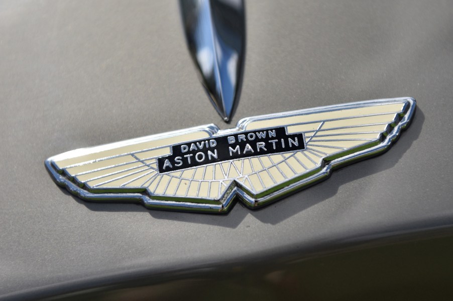 Detail shot of company owner David Brown's name in the hood ornament of a classic Aston Martin sports car.