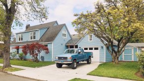 A blue pickup truck parked in a driveway