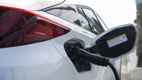 A white EV charging outdoors.