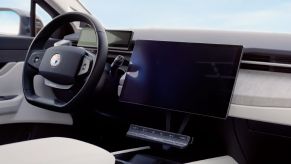 The interior of the 2023 Fisker Ocean, featuring its steering wheel, infotainment screen, and dashboard