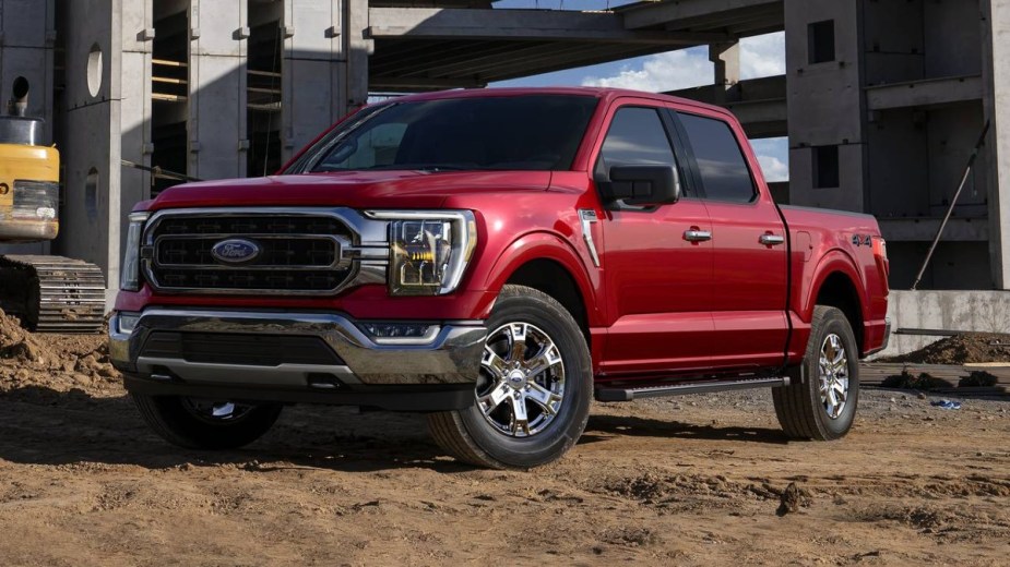 Red Ford F-150 Lariat parked at a job site