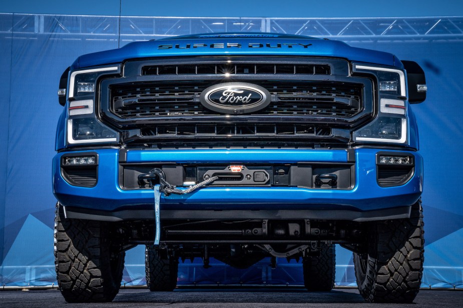 Closeup of the grille and bumper of a Ford F-250 Super Duty Tremor outfitted with a Warn winch for 4x4 off-roading.