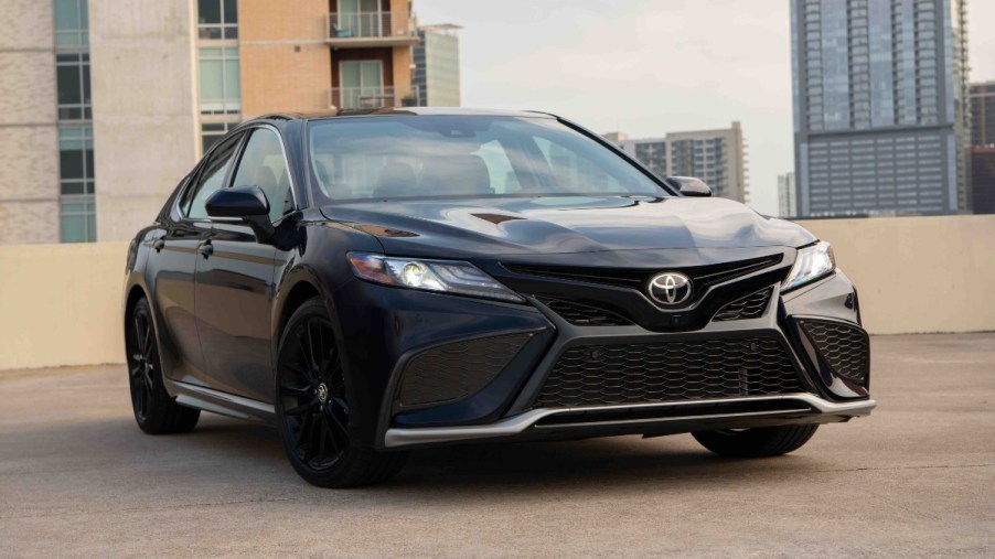 Front angle view of Midnight Black Metallic 2023 Toyota Camry midsize sedan