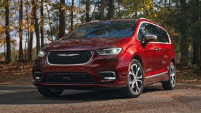 Front angle view of new Velvet Red Pearlcoat 2023 Chrysler Pacifica minivan, which has all-wheel drive (AWD) for traction