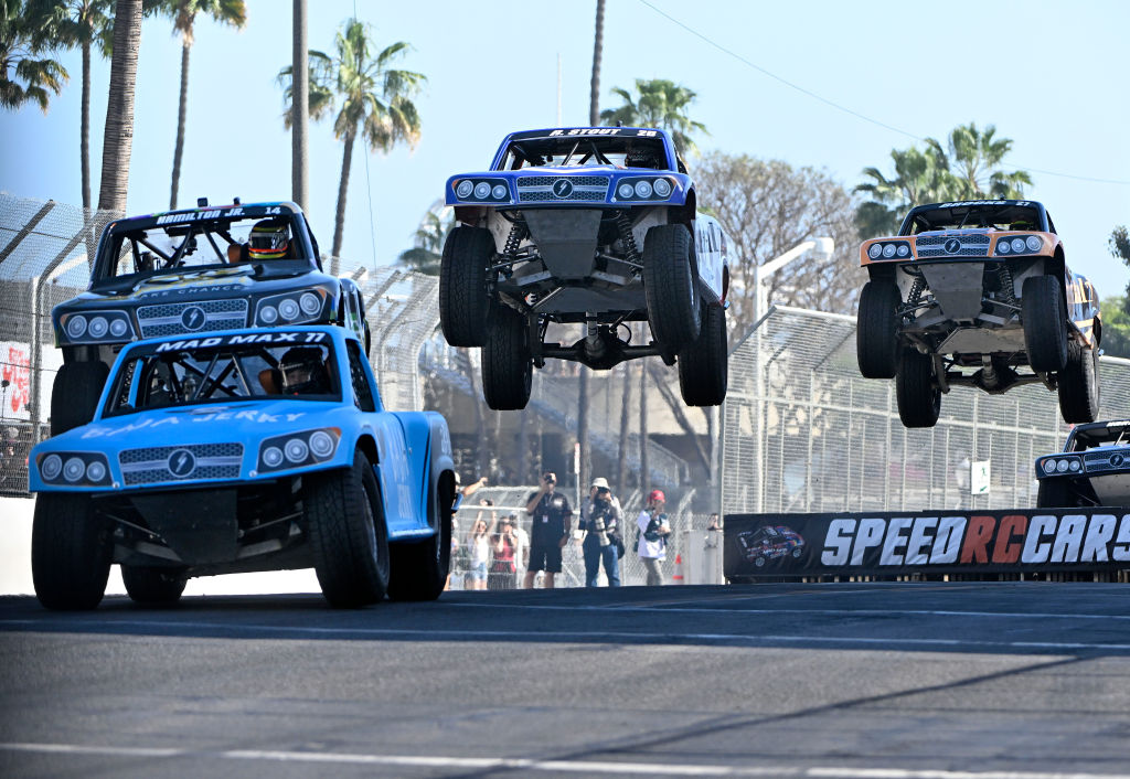 Three stadium super trucks jumping