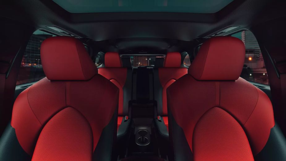 Red interior of a 2022 Toyota Highlander three-row suv. Why is the XLE trim the most popular?