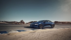 A Lucid Air Sapphire driving around a corner