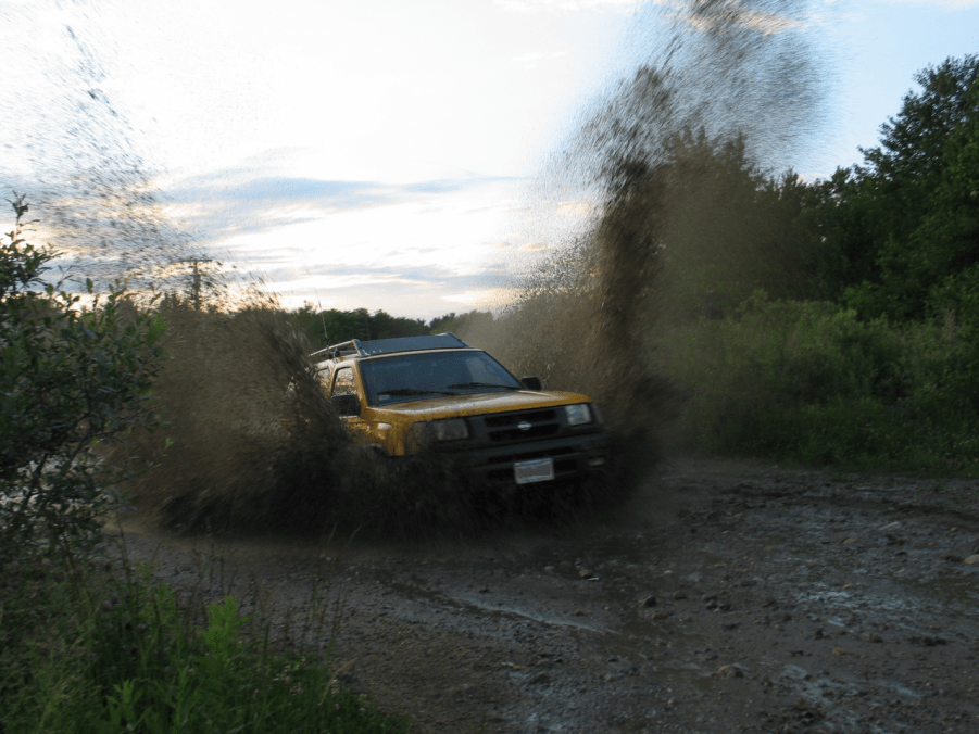 A Nissan Xterra shows off its capability as an off-road SUV.