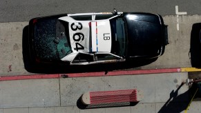 Bird's eye view of a black and white police car in Los Angeles, the numbers on its roof clearly visible.