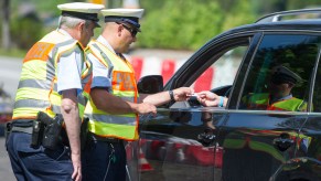 Police pulling over a car that potentially don't have insurance.