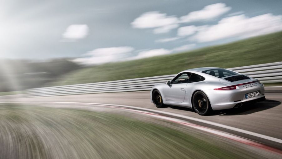 A Porsche 911 Carrera 4 GTS rips around a track.