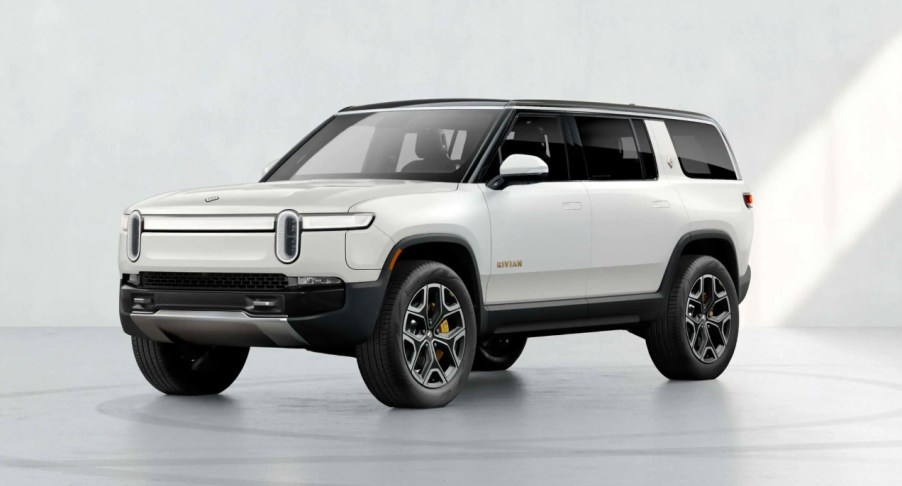 A white 2022 Rivian R1S electric SUV is parked.