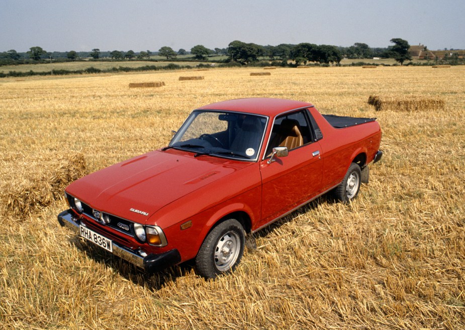 A Subaru Brat ute sits in an open field. 