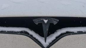 A Tesla EV parked in cold weather and covered in snow in Edmonton, Alberta, Canada