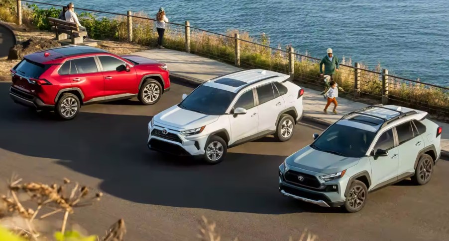 Three Toyota RAV4 small SUVs are parked.