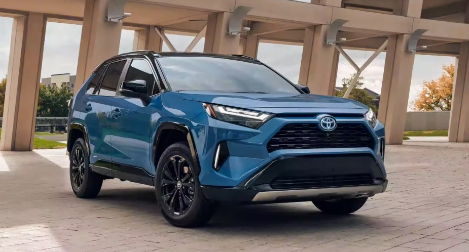 A blue 2022 Toyota RAV4 Hybrid small SUV is parked. 