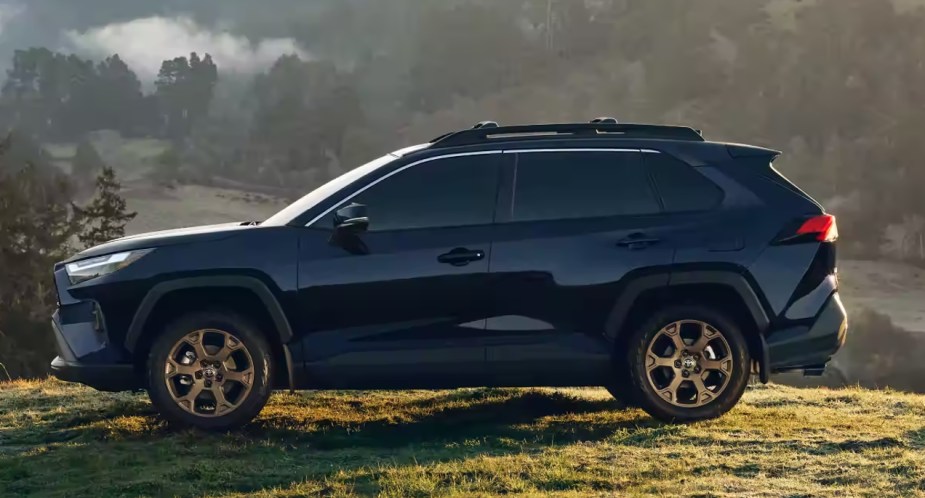 A blue 2023 Toyota RAV4 Hybrid Woodland Edition is parked. 