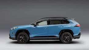 A blue 2022 Toyota RAV4 XSE compact SUV model promotional side shot photo