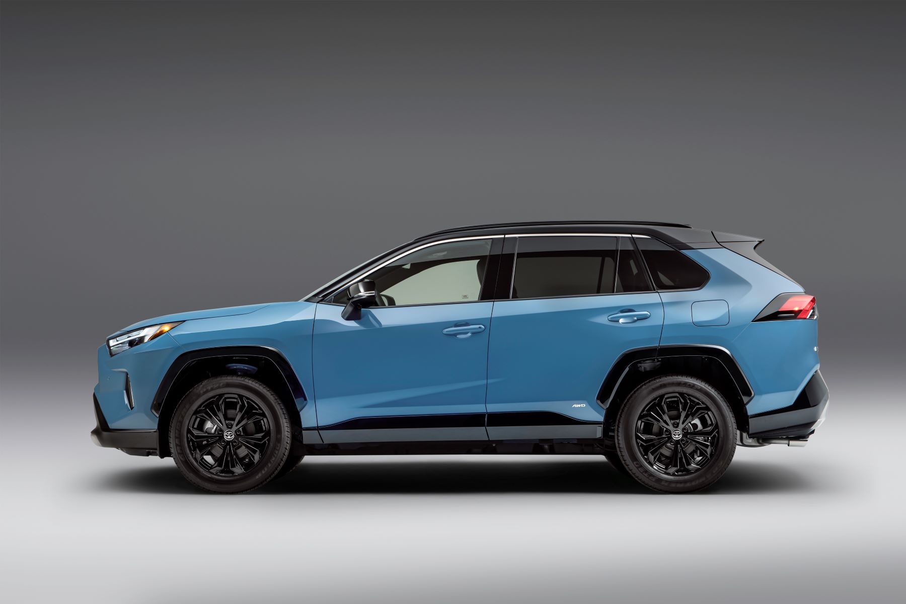 A blue 2022 Toyota RAV4 XSE compact SUV model promotional side shot photo