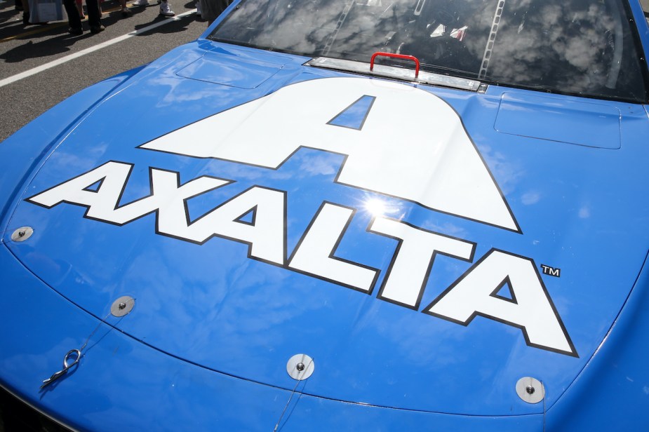 A set of hood pins on a blue Nascar race car.