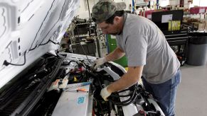 Working under the hood of a Ford Transit Connect Electric vehicle which lacks an oxygen sensor