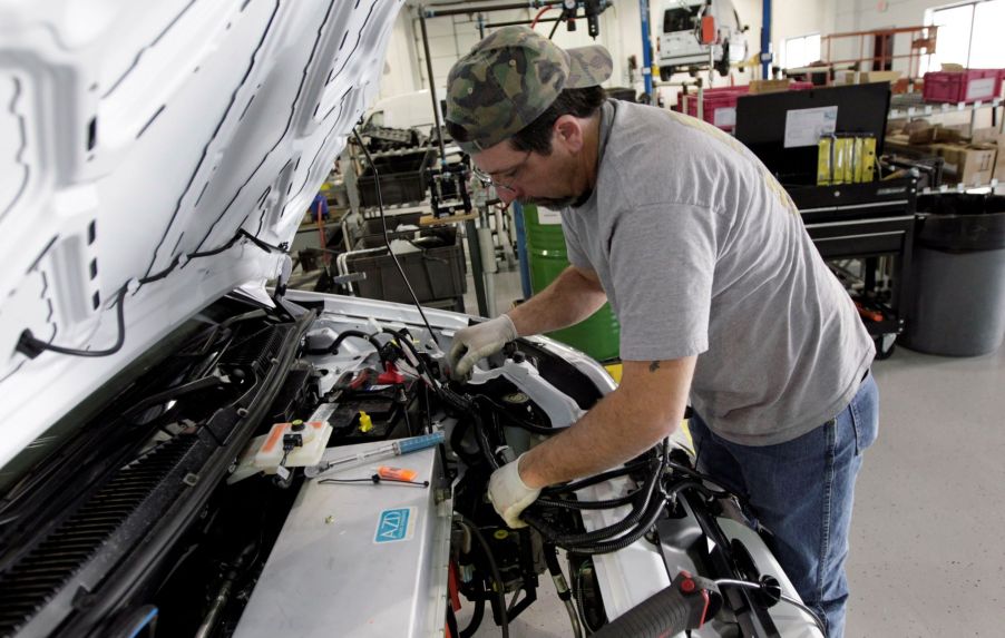 Working under the hood of a Ford Transit Connect Electric vehicle which lacks an oxygen sensor