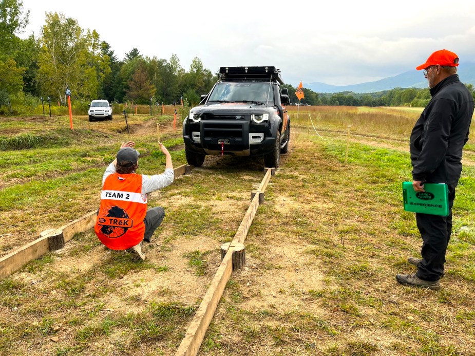 Team Two completing the challenge of driving the Land Rover over a tiny bridge.