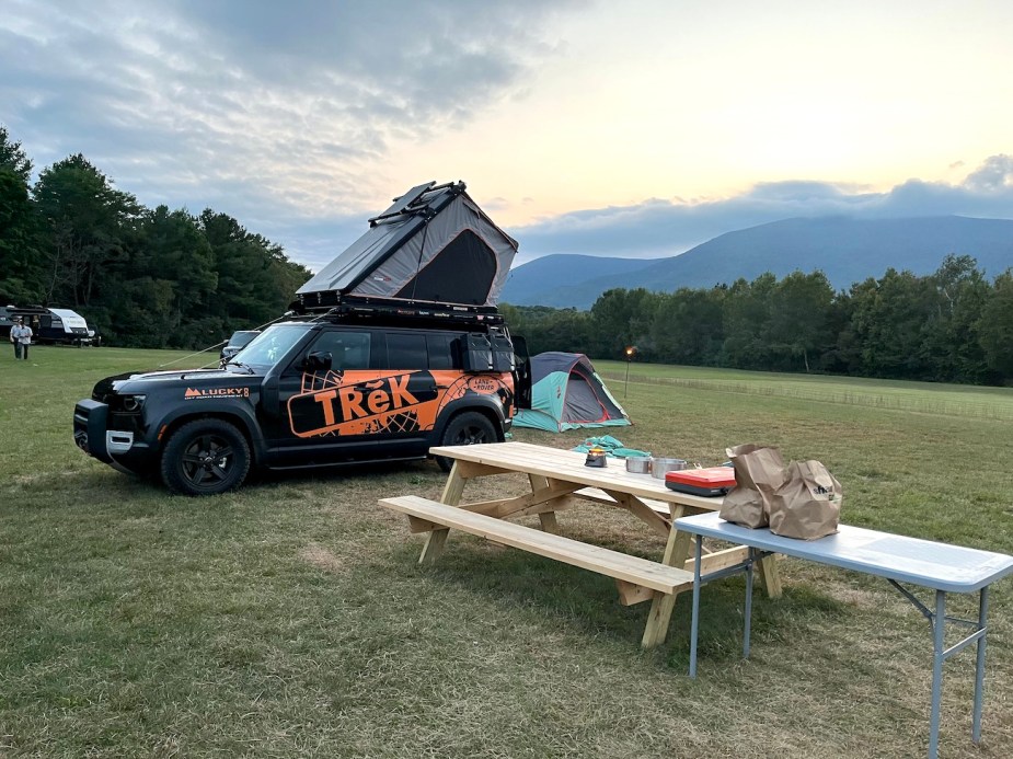 A Defender 110 set up at the campsite.