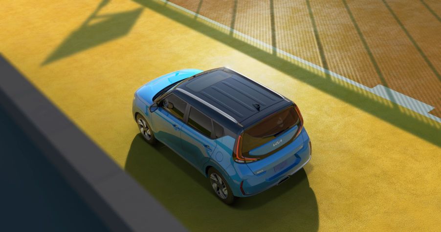 An overhead shot of a blue 2023 Kia Soul subcompact SUV/MPV on a strip of yellow road