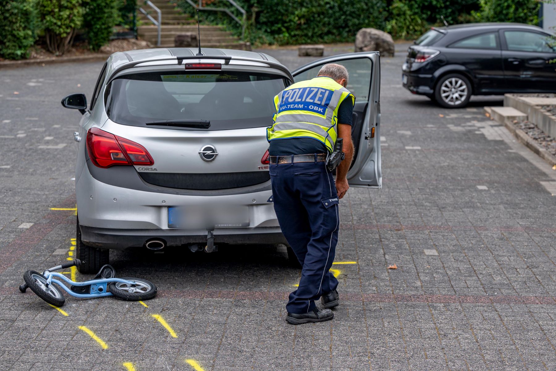 Police inspecting a parking lot accident outside of a bank in North Rhine-Westphalia, Marienheide