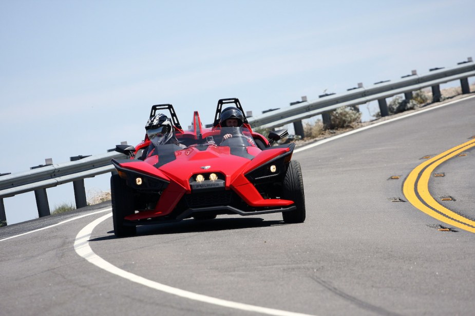 A Polaris Slingshot drives through a corner.