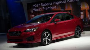 A red 2017 Subaru Impreza sedan introduced at the New York International Auto Show