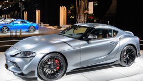 A Toyota Supra with black wheels on display.