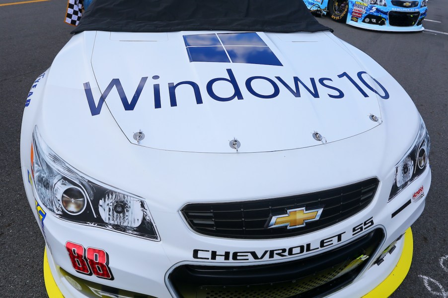 A set of hood pins on a white race car.