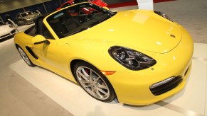 A yellow 2012 Porsche Boxster, which is a used luxury sports cars