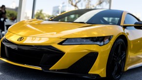 A yellow 2022 Acura NSX parked indoors.