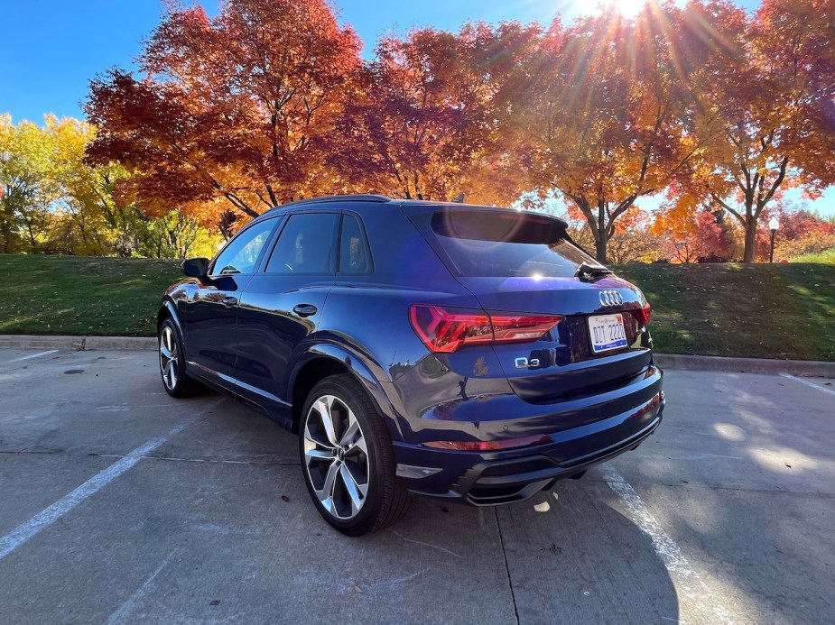 A rear view of the 2022 Audi Q3 near trees