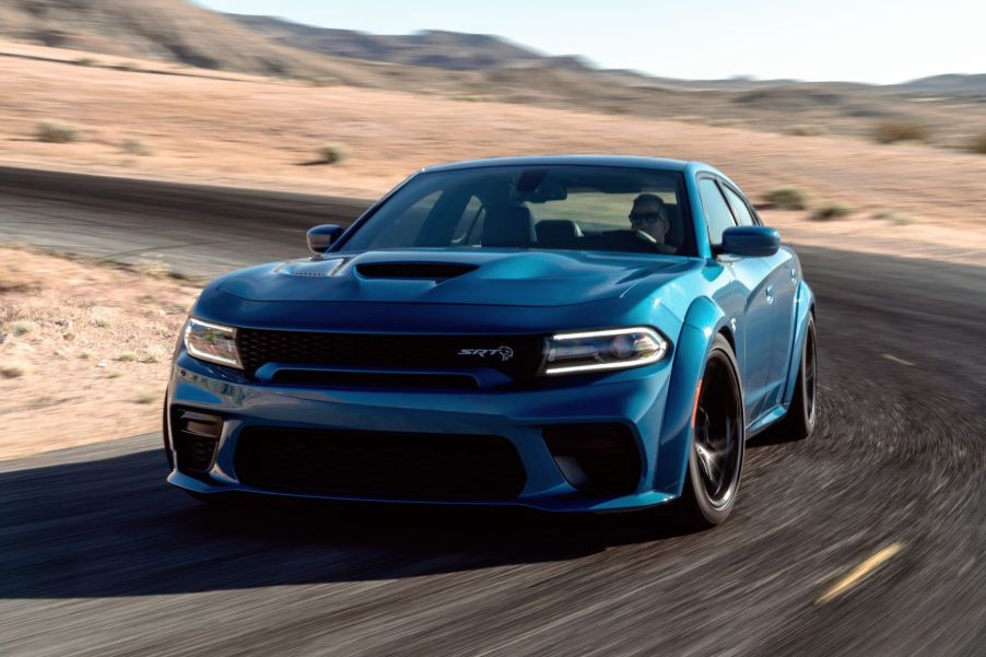 A blue 2022 Dodge Charger SRT Hellcat Redeye muscle car driving on a desert highway