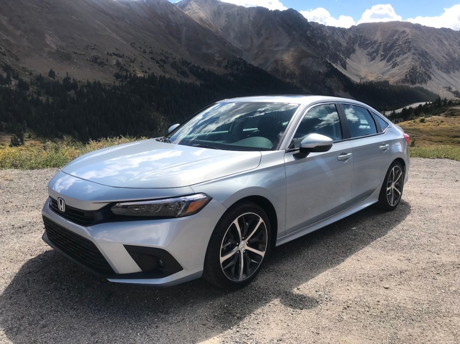 The 2022 Honda Civic parked by a mountain.