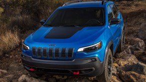 Blue 2022 Jeep Cherokee Trailhawk Crawling on Rocks