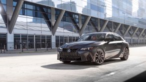 A dark grey 2022 Lexus IS midsize luxury sedan parked