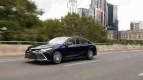 A Black 2022 Toyota Camry AWD sedan driving, the Camry is one of the bestselling cars of 2022